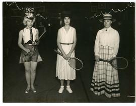 Photograph: Three people wearing historical tennis dress from the 19th century, mid 20th century ...